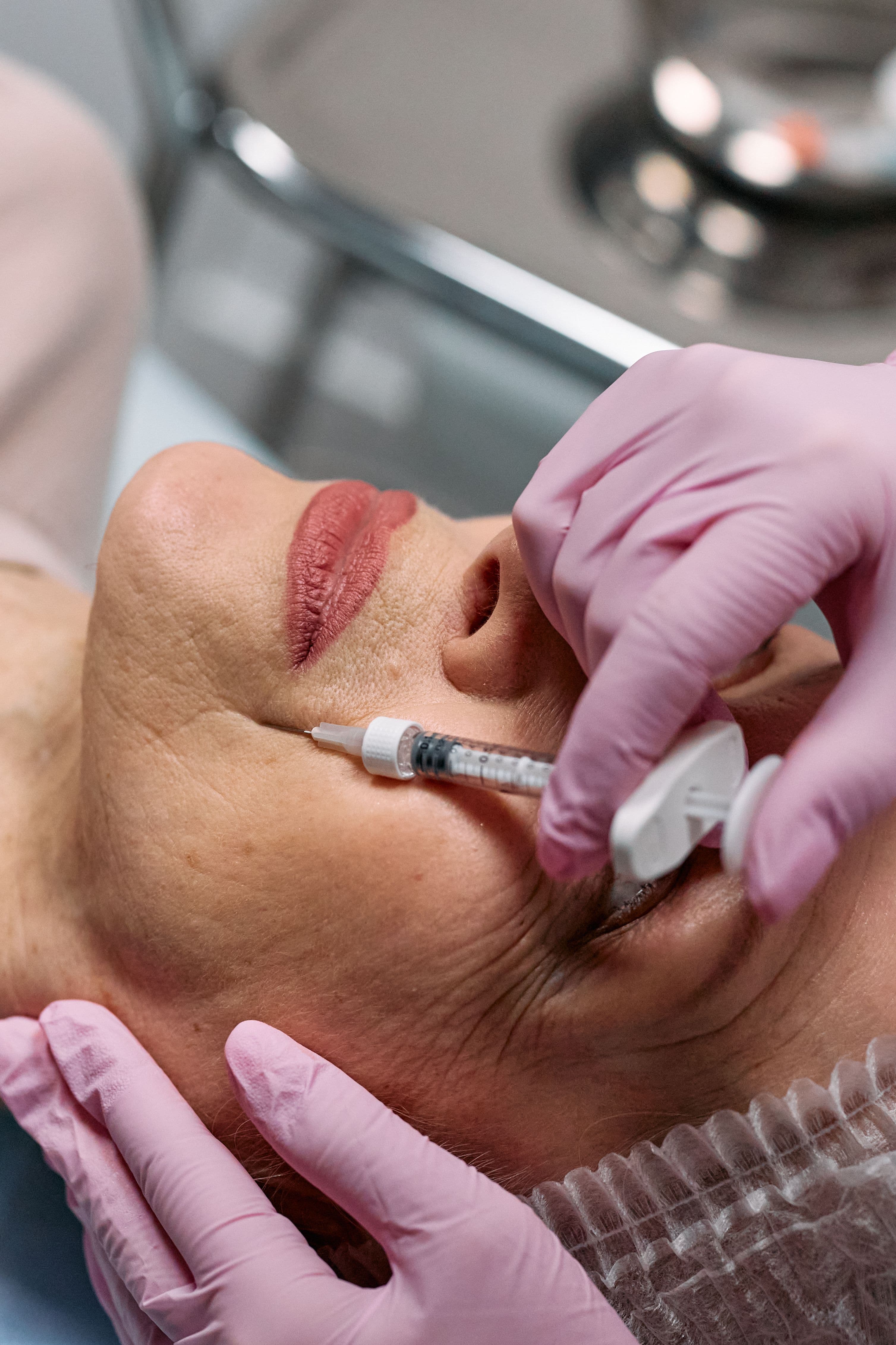 A licensed provider administering a precise facial injection during a consultation
